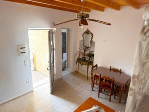 a dining room with a table and a ceiling fan at Bella Casa Lydia - Peaceful Retreat in Rhodes in Rhodes Town +4 photos