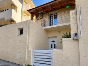 a house with a white gate in front of it at Bella Casa Lydia - Peaceful Retreat in Rhodes in Rhodes Town