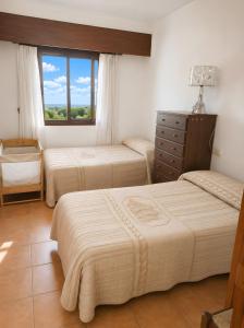 three beds in a room with a window at Ca La Morancica in Yátova +34 photos