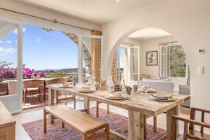 a dining room with a table and chairs and a large window at Villa du Claoux Superieur in Vence