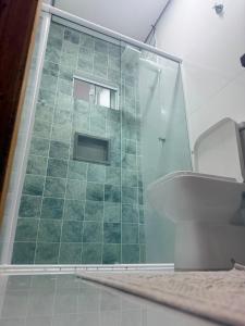 a bathroom with a glass shower and a toilet at O mais charmoso do centro in Sinop +23 photos