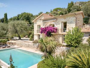 a villa with a swimming pool and a house at Villa du Claoux Superieur in Vence