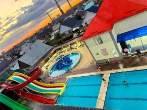 an overhead view of a swimming pool with slides at Aqua Hotel in Bishkek