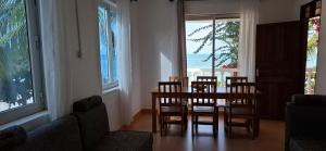a dining room with a table and chairs and the ocean at Villa Mina beachhouse in Jambiani