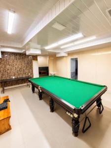 a billiard room with a green pool table at Aqua Hotel in Bishkek