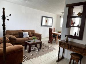a living room with a couch and a table at Casa Rincón Colonial, Confort y tranquilidad in San Miguel de Allende
