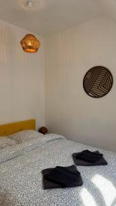 a bedroom with a bed with two towels on it at Le Cœur de Saint-Aignan in Saint-Aignan