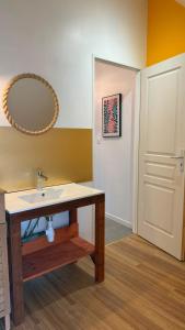 a bathroom with a sink and a mirror on the wall at Le Cœur de Saint-Aignan in Saint-Aignan