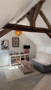 a bedroom with a bed and a table at Le Cœur de Saint-Aignan in Saint-Aignan