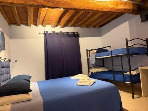 a bedroom with a bed and two bunk beds at La casa di Samarcanda in Uliveto Terme