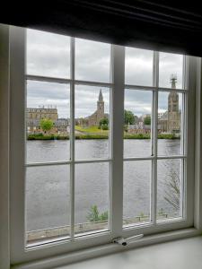 a window with a view of a body of water at No. 41 Town House in Inverness
