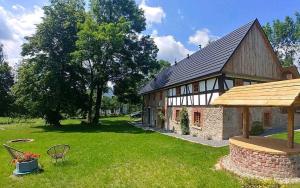 a large brick building with a yard with a bench at Dom w Gajówce u podnóża Gór Izerskich in Gajowka +62 photos