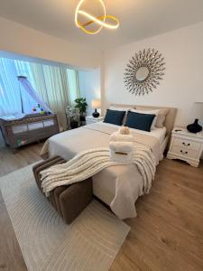 a bedroom with a large bed and a mirror at Urban Central Hub in Giurgiu