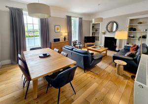a living room with a wooden table and a dining room at No. 41 Town House in Inverness