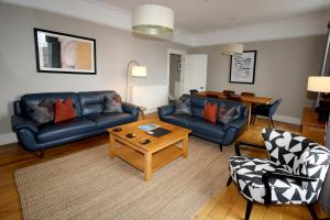 a living room with two couches and a table at No. 41 Town House in Inverness
