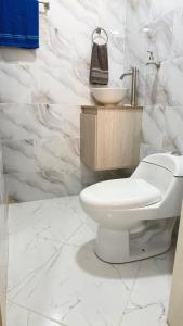 a white bathroom with a toilet and a sink at Comodo aparta estudio en Jerico Antioquia in Jericó +13 photos