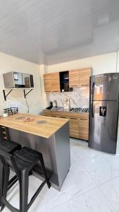 a kitchen with a stainless steel refrigerator and a counter at Comodo aparta estudio en Jerico Antioquia in Jericó