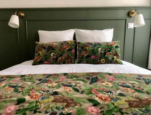a bed with two pillows on top of it at Le Couvent des Ecrevisses in Barjols