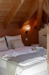 a large bed in a room with wooden ceilings at Casa Prana in Tegna