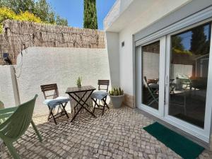 a patio with chairs and a table on a patio at IN-Cascais - Suite Deluxe with Terrace & Villa with Pool in Cascais