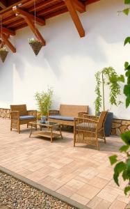 a patio with three benches and a table at Rodzinny zakątek "U Głuszków" Bieszczady in Myczkowce