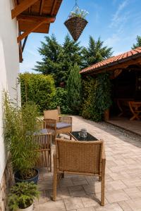 a patio with wicker chairs and a table at Rodzinny zakątek "U Głuszków" Bieszczady in Myczkowce +53 photos