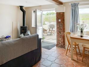 a living room with a couch and a table at The Cartshed - Uk50426 in Malton