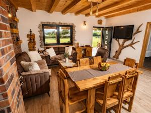 a living room with a wooden table and chairs at Villa MaLea in Neum