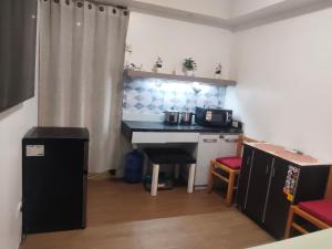 a kitchen with a counter and a table in a room at Staycationbabe Gwen in Manila