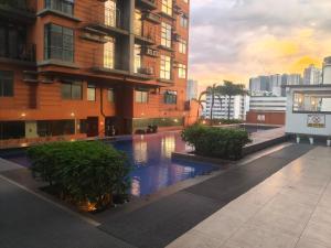 a swimming pool in the middle of a building at Staycationbabe Gwen in Manila