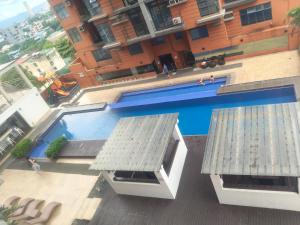 an overhead view of a swimming pool in front of a building at Staycationbabe Gwen in Manila