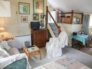 a living room with a couch and a table at Garden Flat in Pilton
