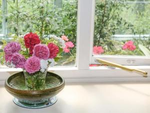 a vase of flowers sitting on a window sill at Garden Flat in Pilton