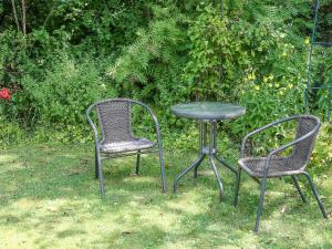 two chairs and a table and a table and chairs at Garden Flat in Pilton