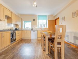 a large kitchen with a wooden table and chairs at The Knott - Uk49161 in Silverdale +9 photos