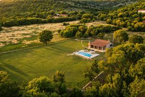 an aerial view of a house with a pool in a field at Villa MaLea in Neum