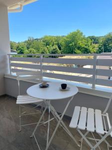 a white table and two chairs on a balcony at Villa Giovanna Rooms in Montelabbate