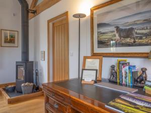 a desk with books and a picture of a sheep at The Cottage - Ukc9711 in Winster