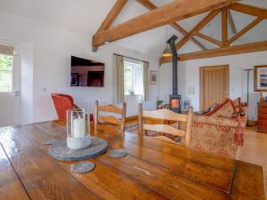 a dining room and living room with a wooden table at The Cottage - Ukc9711 in Winster