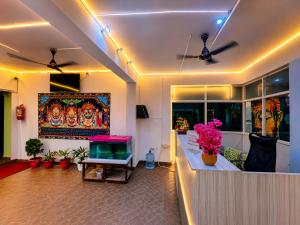 a living room with a fish tank on the wall at Annapurna Prestine Puri - Comfortable Stay Near Jagannath Temple - with Free Wi-fi, Parking, Restaurant in Puri +11 photos