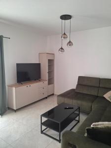 a living room with a couch and a flat screen tv at Adriatic Pearl Povile in Povile