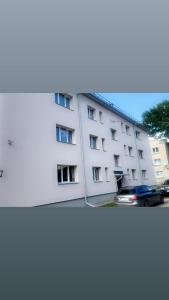 a white building with a car parked in front of it at ST Luxury Apartment Riga in Riga