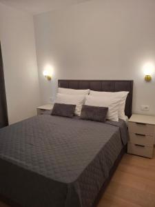 a bedroom with a large bed with two pillows at Adriatic Pearl Povile in Povile