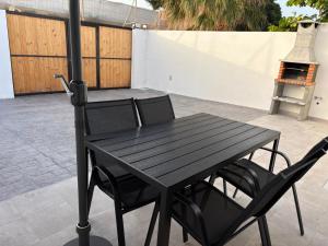 a black table and chairs on a patio at La Casita de Kai in El Médano