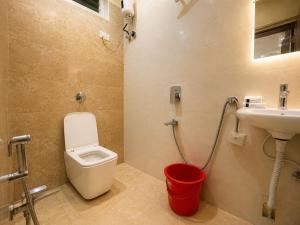 a bathroom with a toilet and a sink at Annapurna Prestine Puri - Comfortable Stay Near Jagannath Temple - with Free Wi-fi, Parking, Restaurant in Puri