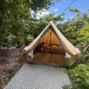 a tent with a wooden floor and a table at Apple Tree glamping near Brighton in Saltdean