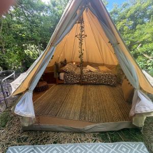 a canopy tent with a bed in it at Apple Tree glamping near Brighton in Saltdean