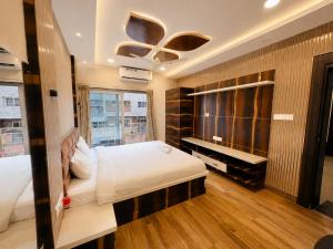 a large bedroom with a bed and a piano at Annapurna Prestine Puri - Comfortable Stay Near Jagannath Temple - with Free Wi-fi, Parking, Restaurant in Puri