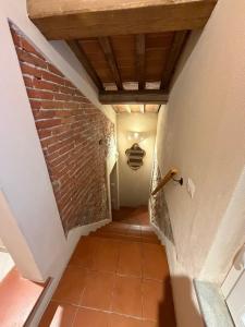an attic hallway with a brick wall and a ceiling at La casa di Samarcanda in Uliveto Terme +13 photos