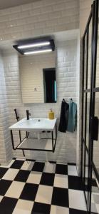 a bathroom with a sink and a mirror at Hotelli Pato in Nakkila